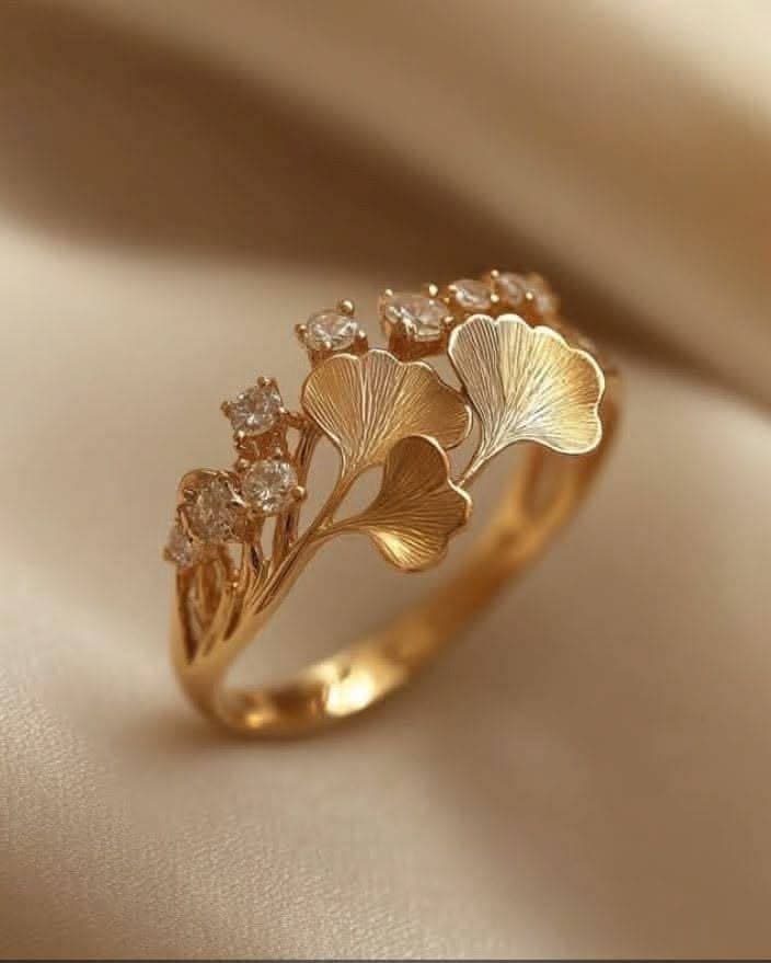 Ginkgo — Three fanned leaves and a run of small stones, sized to be worn every day.