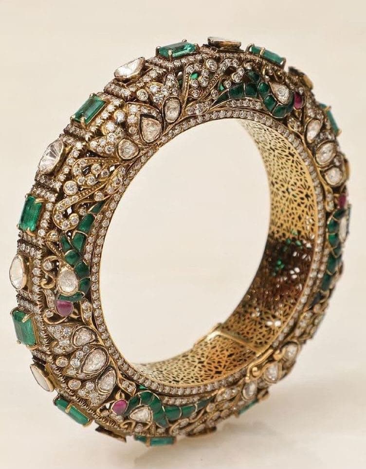 Jaali Kada — A deep kada in polki and pavé, with green stones along its edge and a lining pierced in jaali — made as carefully inside as out.